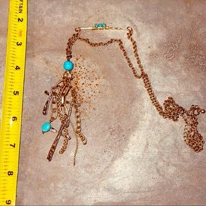 Gold-toned and turquoise bead, cross accents.